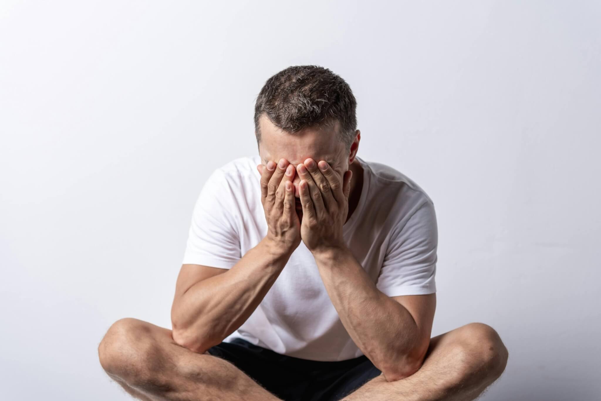 man-sitting-with-palms-on-face